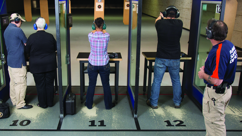 Range Safety Officer Watching Shooters at an Indoor Range